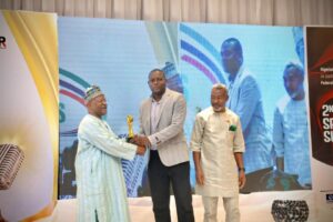 Nigeria Customs Services Spokesperson Abdullah Maiwada receiving his award flanked by NIPR President, Dr. Ike Neliaku