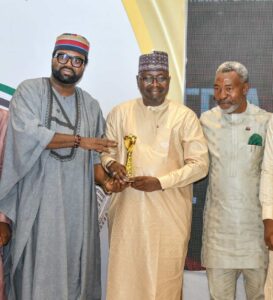 Special Guest of honour, Hon.Akintunde Rotimi Chairman, House Committee, Media & Public Affairs presenting award to Ismaila Uba Misili of Gombe state while NIPR President Dr. Ike Neliaku Assist