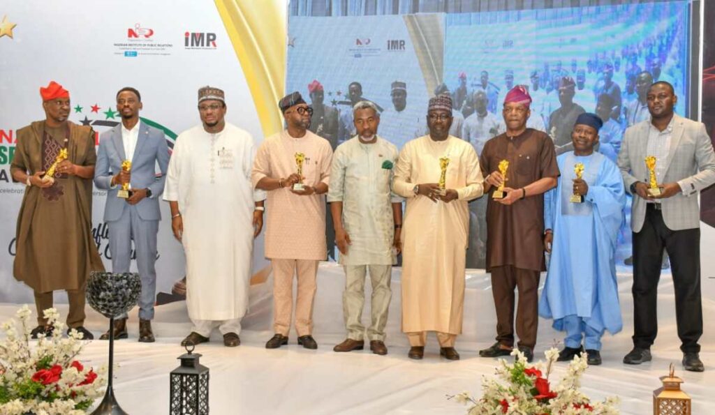 Winners at the 2025 National Spokesperson Awards displaying their trophies.
